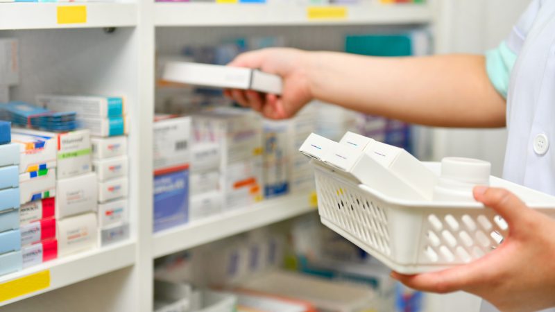 Pharmacist filling prescription in pharmacy store